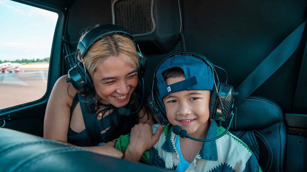 Two people in a vehicle wearing headsets. 2
