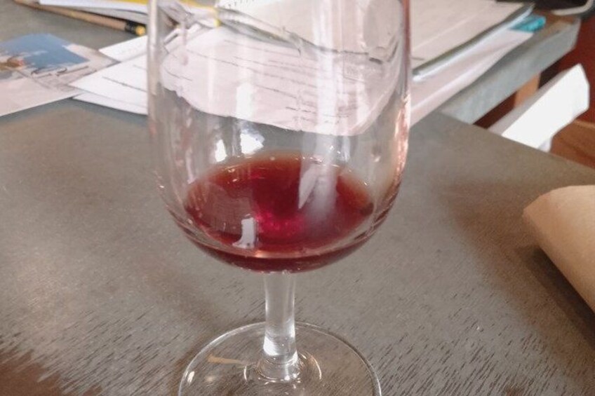 A glass of red wine on a wooden table. 4