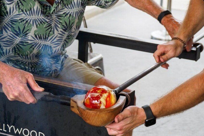 A person grilling a burger on a barbecue grill. 1