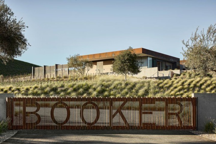 A modern building with a large sign that reads 'BOOKER' in front of it. 5