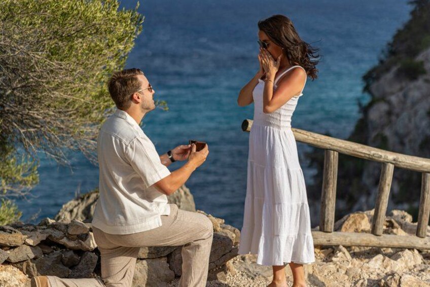 A man proposing to a woman by the seaside. 1