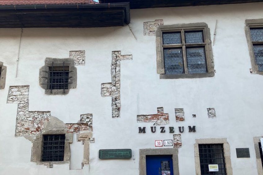 A building with the sign 'MUSEUM' and numbered windows. 2