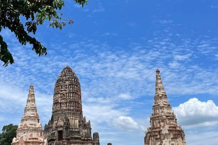 Ancient stone structures with tiered towers against a blue sky. 4