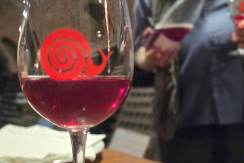 A wine glass with a red swirl design. 3