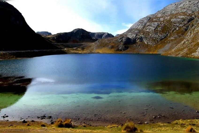 A mountain lake with clear water, surrounded by rocky terrain. 3