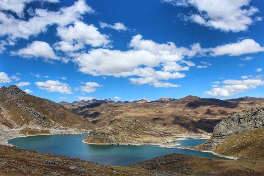 A mountainous landscape with a lake surrounded by rocky terrain. 1