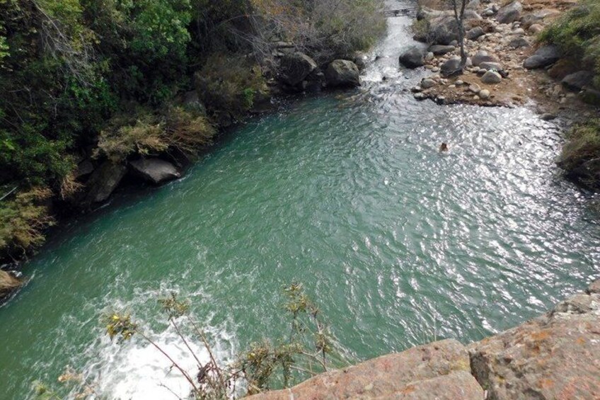 A river flowing through a rocky landscape with dense vegetation on the banks. 5