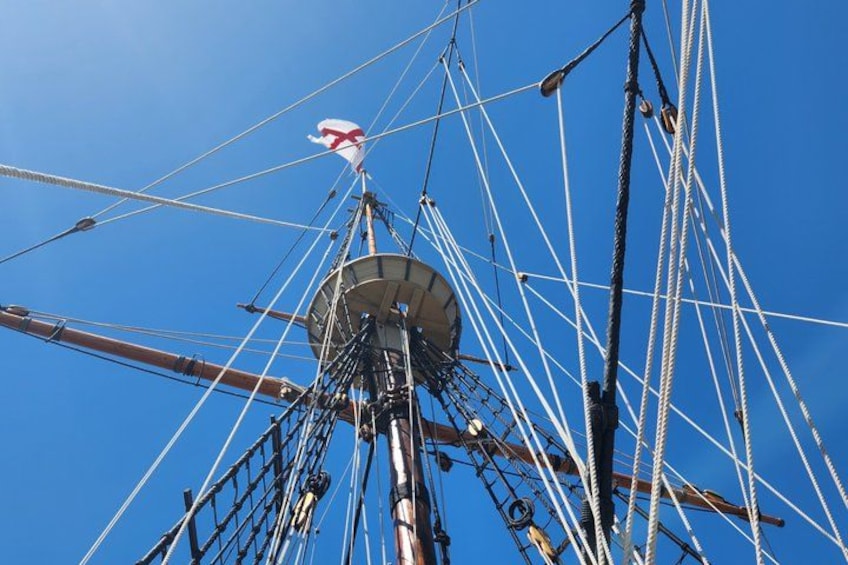 A ship's mast with rigging and a flag. 3