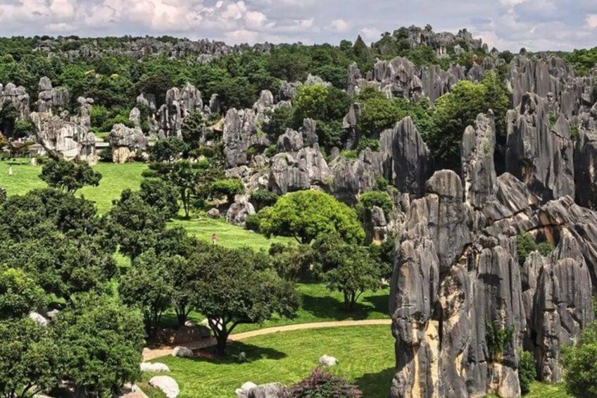 A landscape with rock formations and green trees. 4