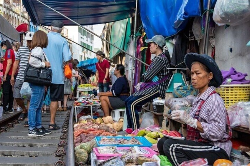 A bustling street market with vendors selling fruits and vegetables. 5