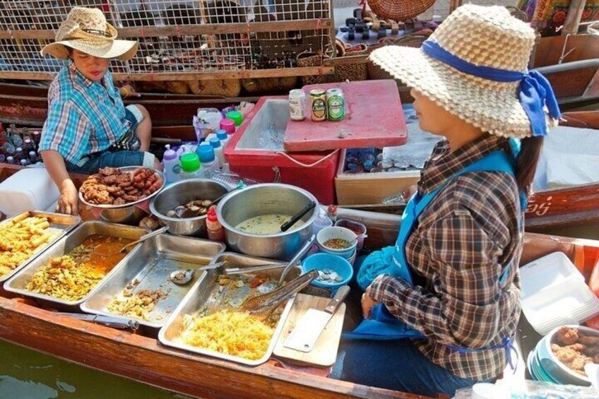 A boat with food stalls and a person wearing a hat. 2