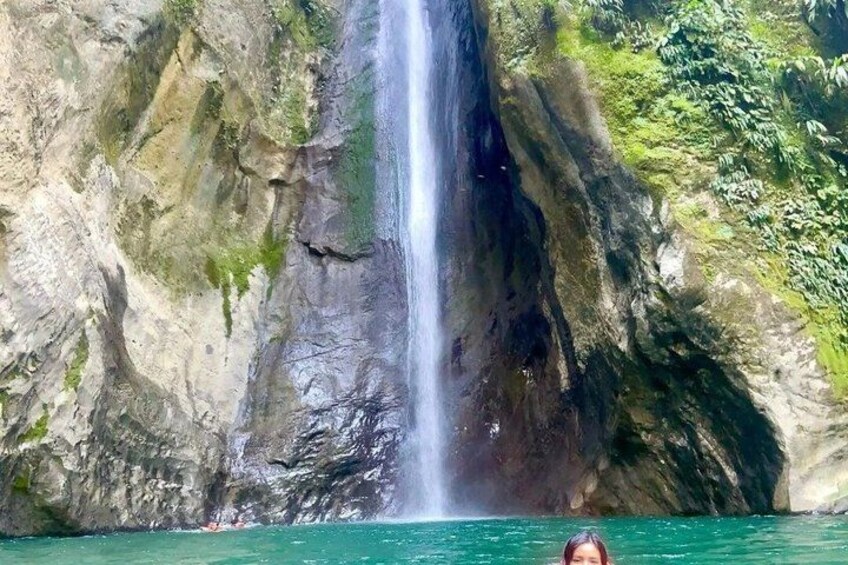 A waterfall, clear water, and rocky cliffs. 1