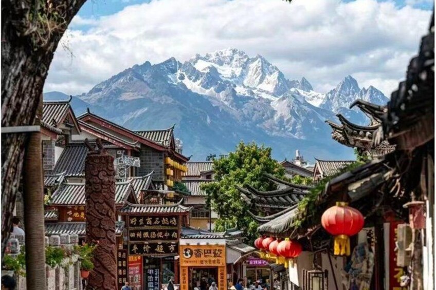 Traditional architecture, a mountain range, and a clear sky. 1