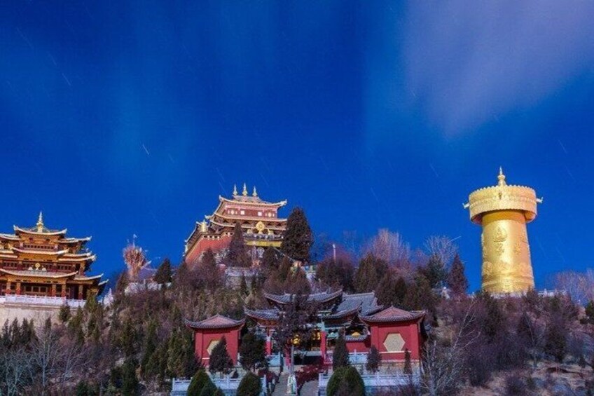 A traditional building with multiple tiers, a golden tower, and a red-roofed structure. 5