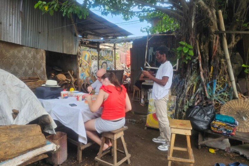A rustic outdoor setting with a table, a ladder, and a person standing. 5