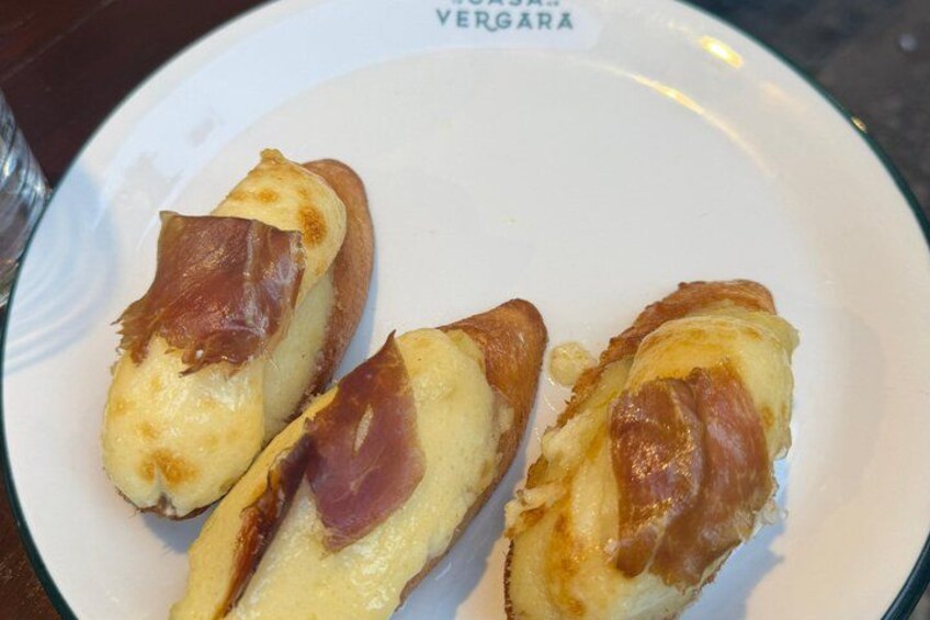 A plate with three pieces of food, possibly a type of pastry or sandwich, with a label that reads 'VERGARA'. 2