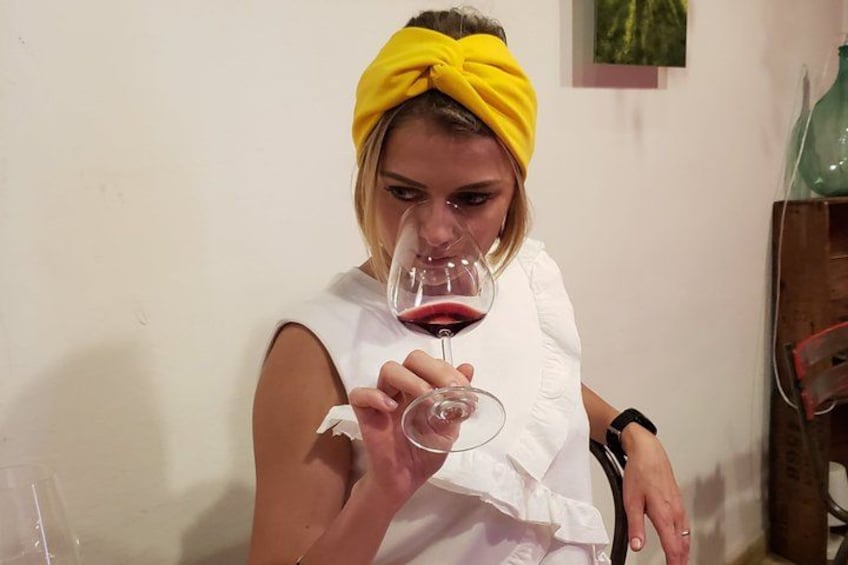 A person holding a wine glass. 1