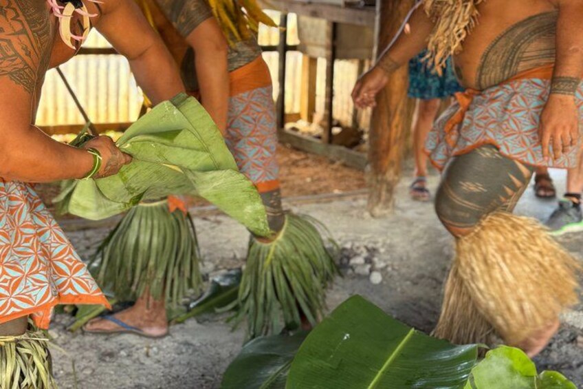 People preparing food with leaves and hands. 4