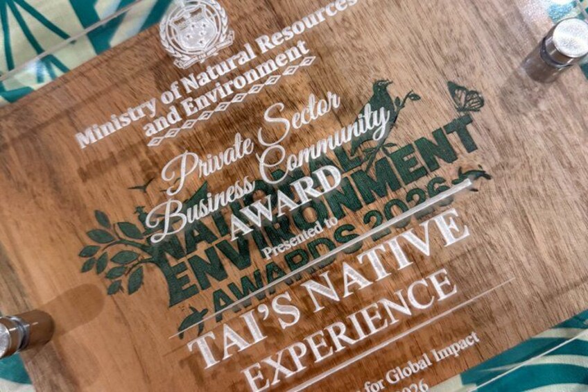 A wooden plaque with text and logos, including 'Ministry of Natural Resources and Environment' and 'TAI'S NATIVE EXPERIENCE'. 2