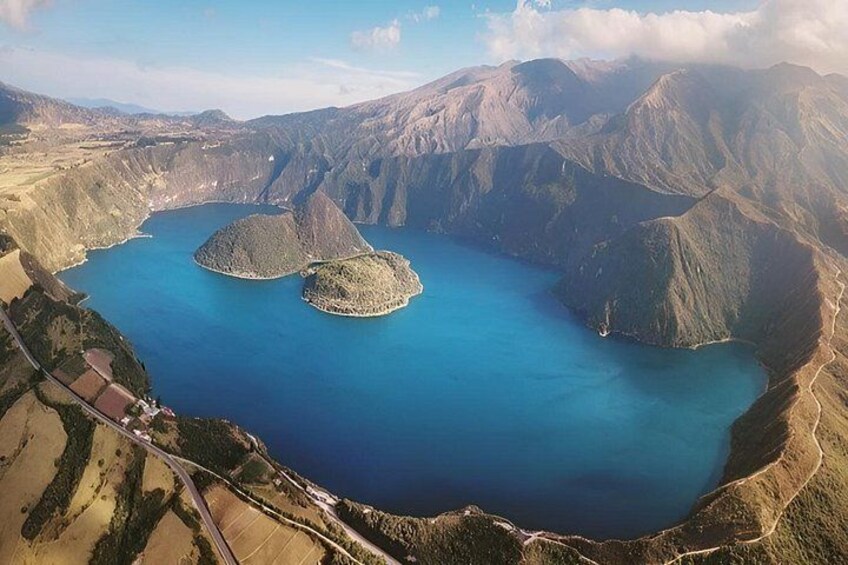 A large lake surrounded by mountains, with two prominent islands in the center. 4