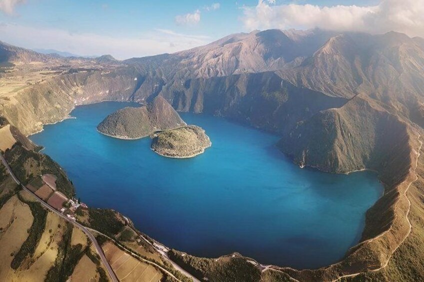 A large lake surrounded by mountains, with two prominent islands in the center. 4