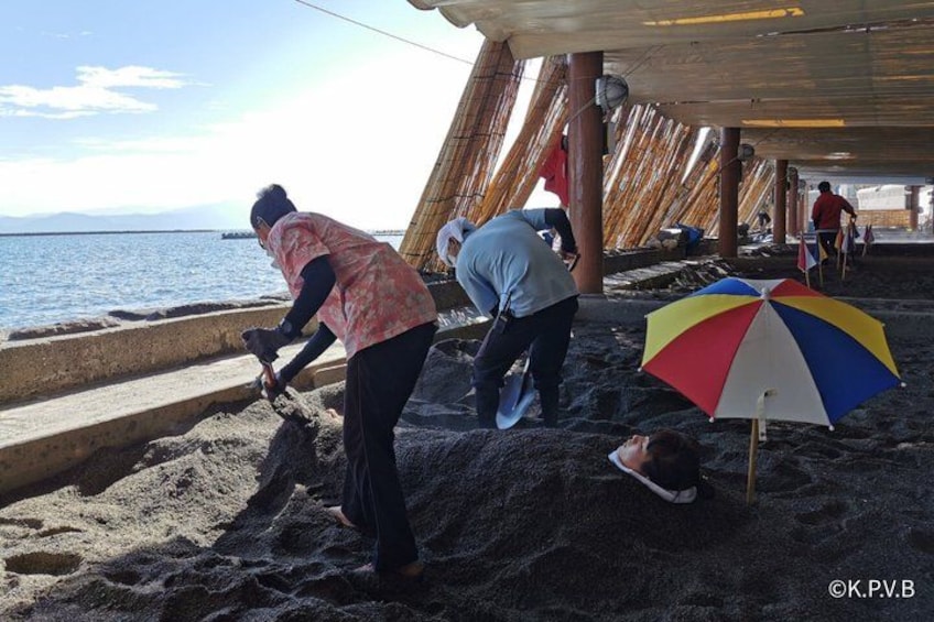 People working on a beach with a beach umbrella. 5