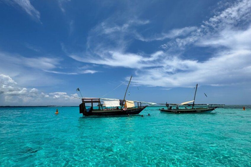 Two boats on turquoise water under a clear sky. 5