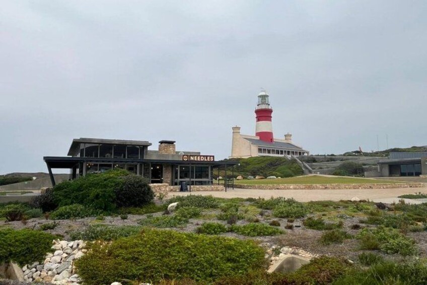 A modern building with a lighthouse in the background. 1