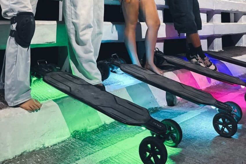 A person standing on a skateboard with colorful lights underneath. 2
