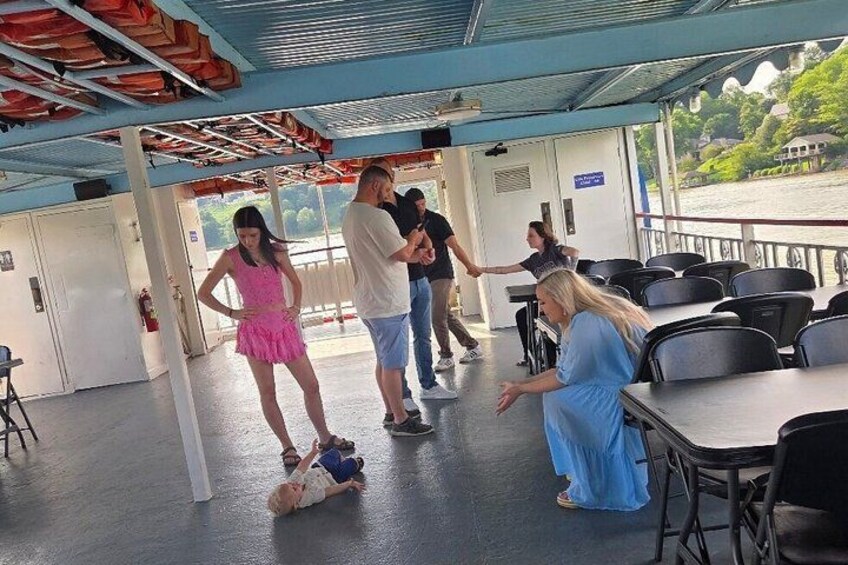 A covered outdoor area with tables and chairs, a person in a pink dress, and another in a blue dress. 4