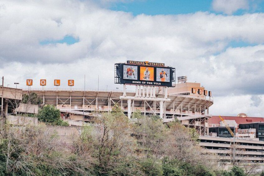 A stadium with a large scoreboard and the letters 'VOL' visible. 2