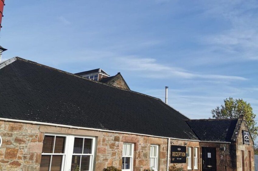 A stone building with a black roof, a chimney, and a sign that reads 'B&B.' 3
