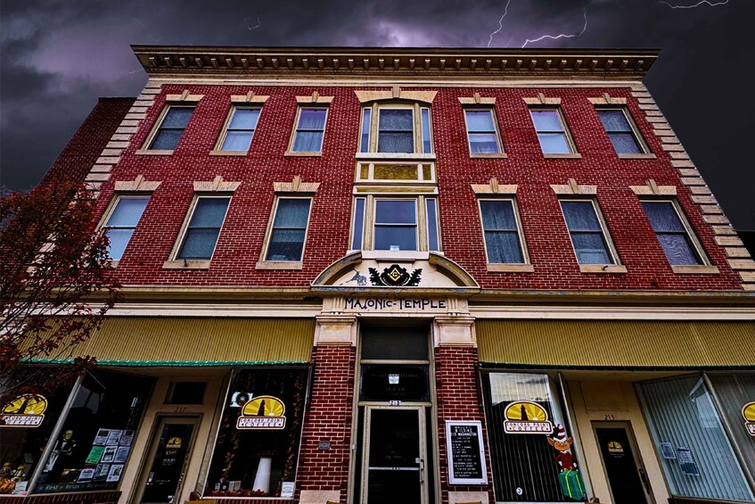 A red brick building with a sign reading 'Masonic Temple' and storefronts with 'Concord Point Coffee' signs. 4