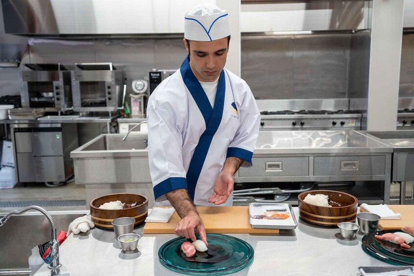 A chef preparing sushi in a professional kitchen. 4