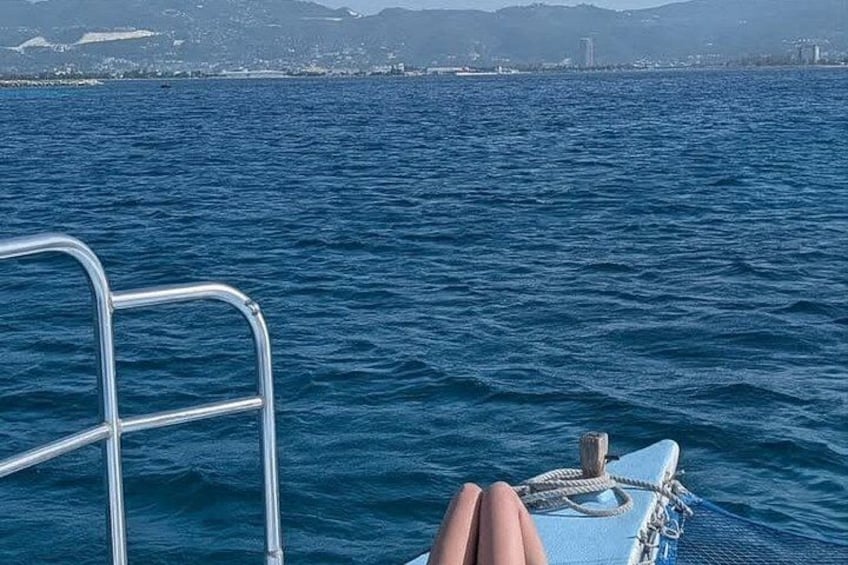 A boat's metal ladder, a rope, and a hand resting on the boat's edge. 4
