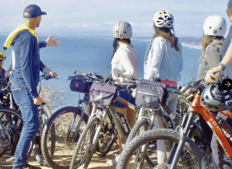 A group of cyclists on a coastal trail with ocean views. 2
