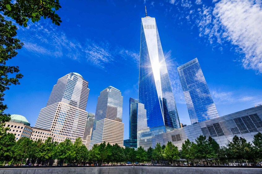 A city skyline with modern skyscrapers, including a prominent tower with a spire. 3