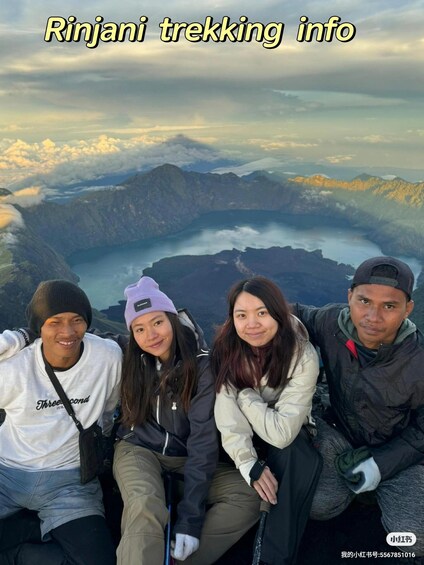 A group of people on a mountain with a lake in the background. 2