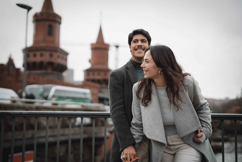 A couple standing in front of a historic building with towers. 2