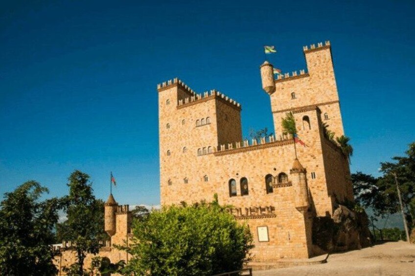 A large stone castle with multiple towers and a flag. 3
