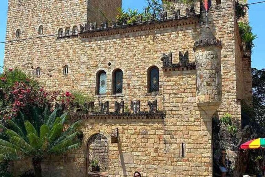 A stone castle with arched windows and a tower. 2