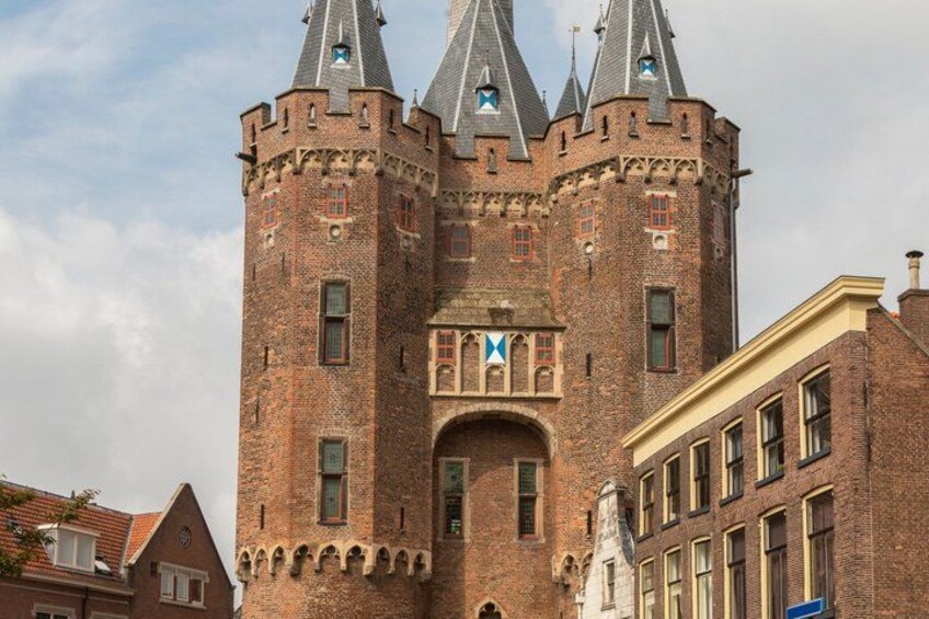 A historic brick castle with multiple towers and a central entrance. 2