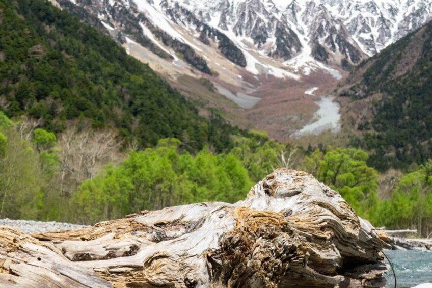 A rugged mountain landscape with a prominent rock formation in the foreground and a glacier in the background. 4