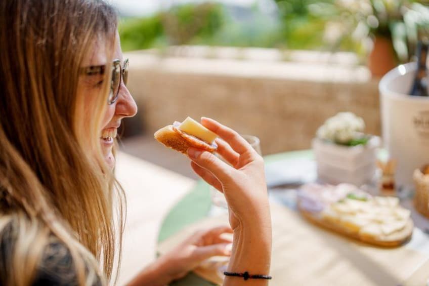 A person holding a pastry with a bite taken out of it. 5