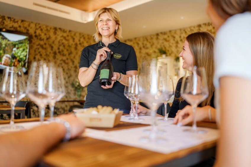 A person serving wine to guests at a restaurant. 1