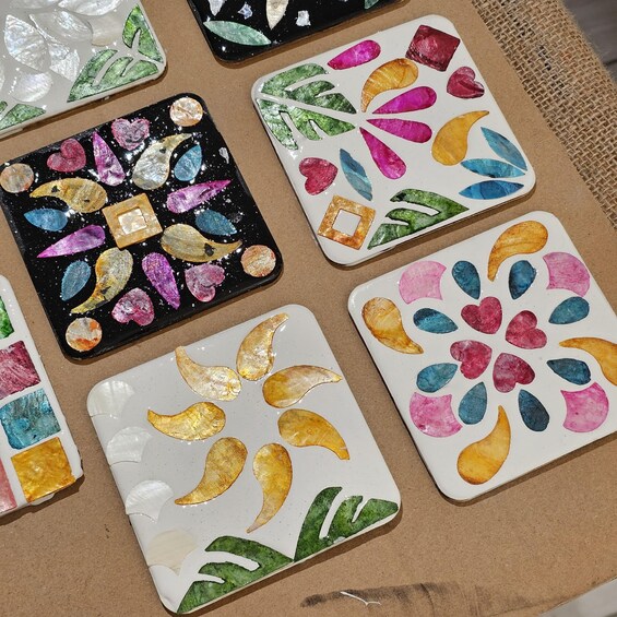 A collection of colorful, hand-painted tiles with various shapes and patterns. 1