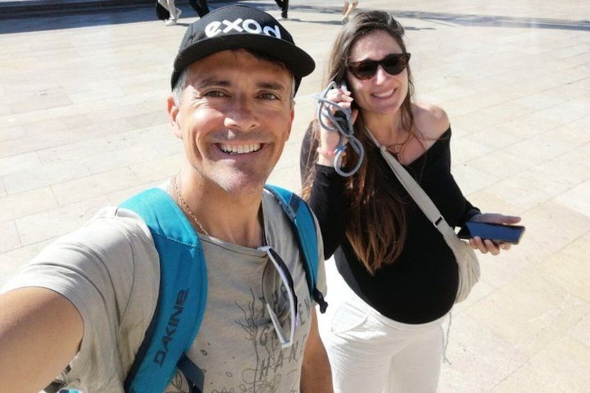 Two people taking a selfie, one with a backpack and the other holding a phone. 1
