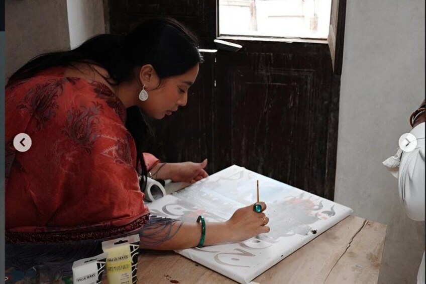 A person painting on a canvas. 2