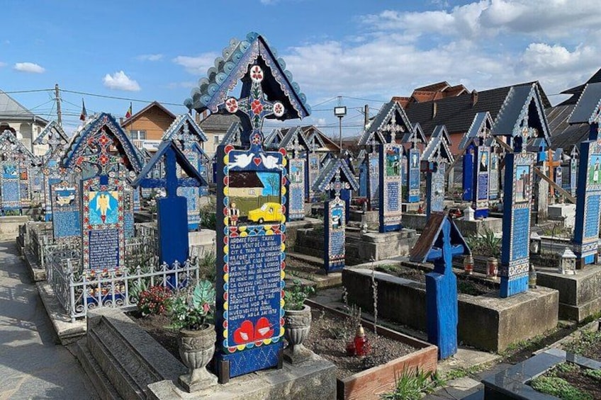 A cemetery with colorful, house-shaped tombstones. 1