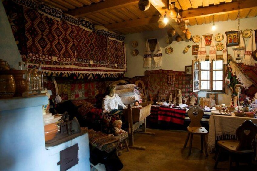 A traditional room with patterned textiles, wooden furniture, and various decorative items. 2